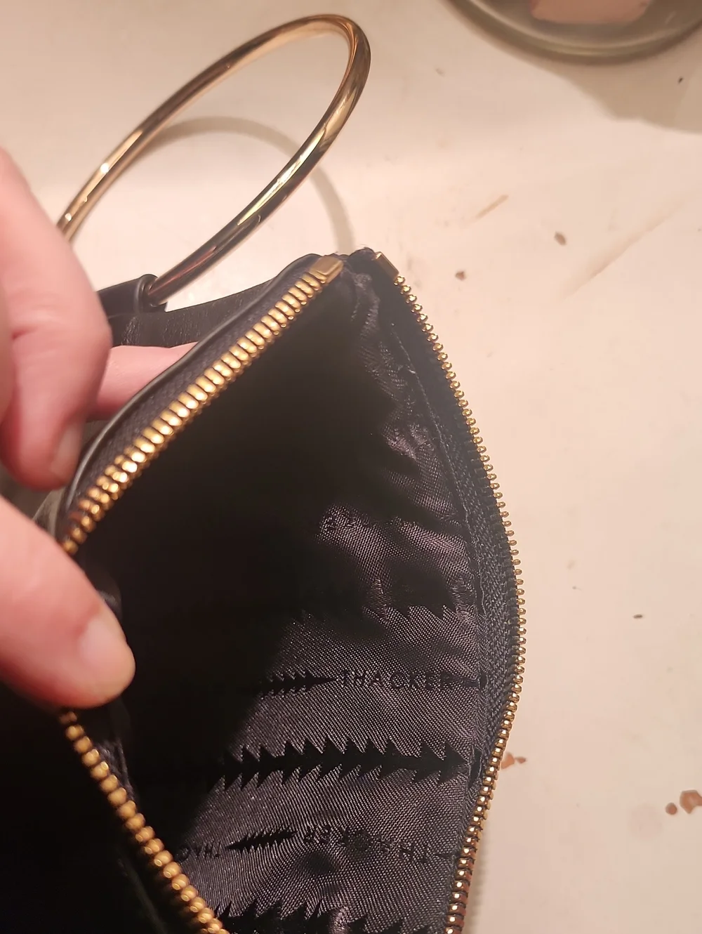 Thacker Black Leather Wristlet Clutch with Gold Ring Handle